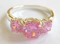 925. sterling silver ring with 3 rounded pinkish cz stone align in middle