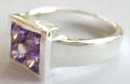 925. sterling silver ring holding 4 mini purple cz stone in middle