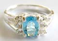 925. sterling silver ring with oval shape light blue and multi mini clear cz stone forming butterfly pattern central decor 