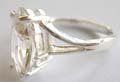 925. sterling silver ring with carved-out Yshape pattern jolding a large olive shape clear cz stone at center