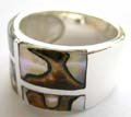 Flat wide band ring made of 925. sterling silver with 4 irregular spotted seashell stone inlaid at center