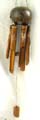 Deep brown bamboo wind chime with full coconut shell top and dragonfly pattern decor on each pipe