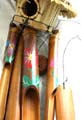 Deep brown bamboo wind chime with rounded retan bird house top and painting flower decor on each pipe