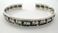 Sterling silver bangle with multi mini carved-out elephant pattern design. 