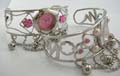 Fashion bangle watch, flower and curve wire pattern on band with sparkle pinkish rounded clock face