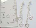 Sterling silver stud earring with chain holding a heart