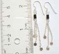 Solid 925. sterling silver fish hook earring with black rectangular holding long chain and flower on the bottom