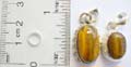 Assorted olive shape tiger eye gemstone with flower inlaid made of 925. sterling silver pendant