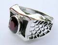 925. stamped sterling silver ring with butterfly knot holding a red garnet gemstone and web pattern on each side