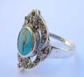925. sterling silver ring with multi marcasites in cut-out olive shape pattern design holding a rounded turquoise stone