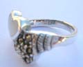 Sterling silver ring with 1 heart of white mother of pearl seashell and 1 heart of marcasites embedded central design