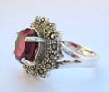 Multi marcasites beaded in olive shape design sterling silver ring holding a oval red cz stone in middle