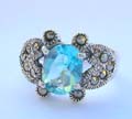 Multi marcasites beaded in heart shape aside holding a oval light blue cz stone in middle