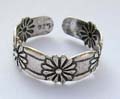 Sterling silver toe ring with carved-in flower pattern decor around 