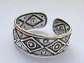 Sterling silver toe ring with carved-in circle and diamond pattern decor around 