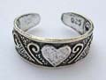 Black sterling silver toering with carved-out dot and heart pattern decor
