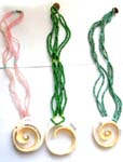 Assorted multi seed bead forming a necklace with white spiral shape seashell pendant