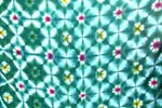 Die-tie sarong wrap motif flower pattern forming in diamond shape design in dark green color