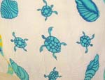 White batik sarong wrap with blue turtle and seashell pattern