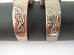 Long rectangular tan style bangle watch with curved-in flower pattern on bangle design