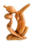 Abstract wood carving with kissing couple in dance movement position