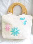White canvas fabric with sequins double wooden handle hand bag motif pink and blue flowers with butterfly on right hand side in sparkle chips and thread work design, also zipper closure and inner zipper pocket