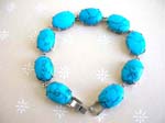 Turquoise fashion bracelet in oval shape with chain lock for closure 