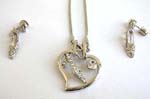 Floating heart shape frame charm holding a clear cz high heel suspended on a snake chain, included a matching pair of high heel studs earrings 