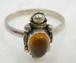 Stamped 925.sterling silver thin band ring in traditional design holding a tiger eye stone in the middle