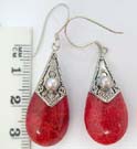 Imitation pearl set in decoratively designs 925. sterling silver mounting, holding coral gem earrings