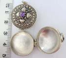 925. Sterling silver locket pendant in crafted beading, framing flower design embedded with amethyst stone in center