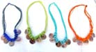 5 mother of pearl shells dangling from multi string necklace with twisted beads at base 