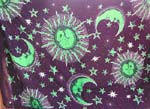 Black background color with green smiling sun, moon and star pattern 